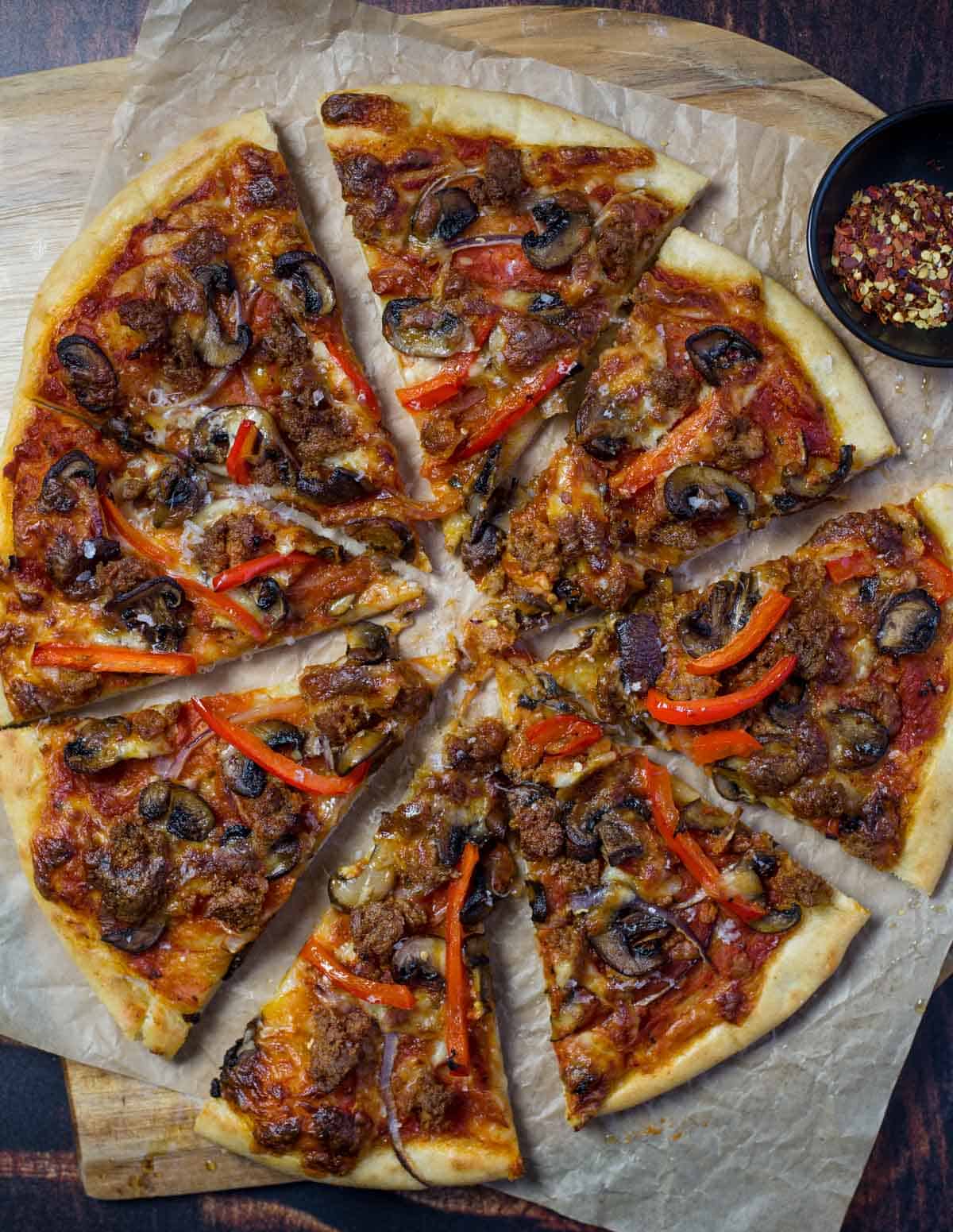 Sausage, mushroom, and peppers pizza cooked on a pellet grill