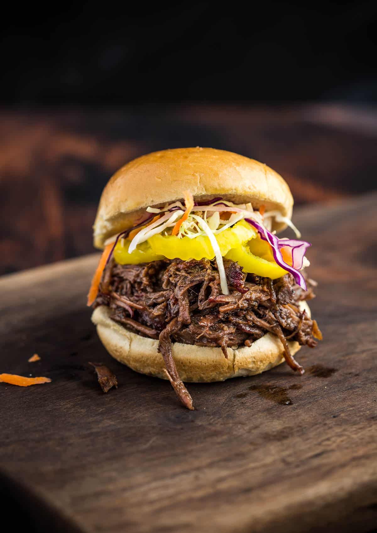 Shredded Smoked Pulled Beef Sandwich on a cutting board