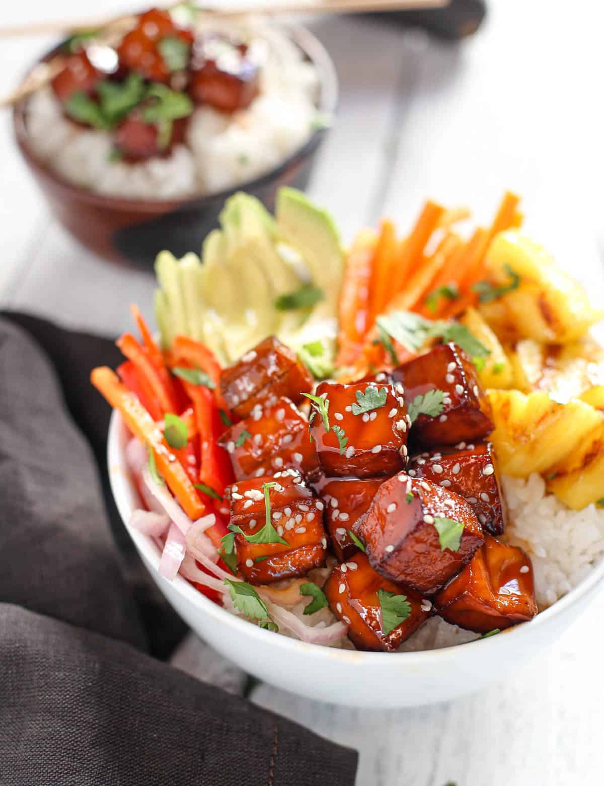 Smoked BBQ Tofu Bowls with vegetables and grilled pineapple in a white bowl