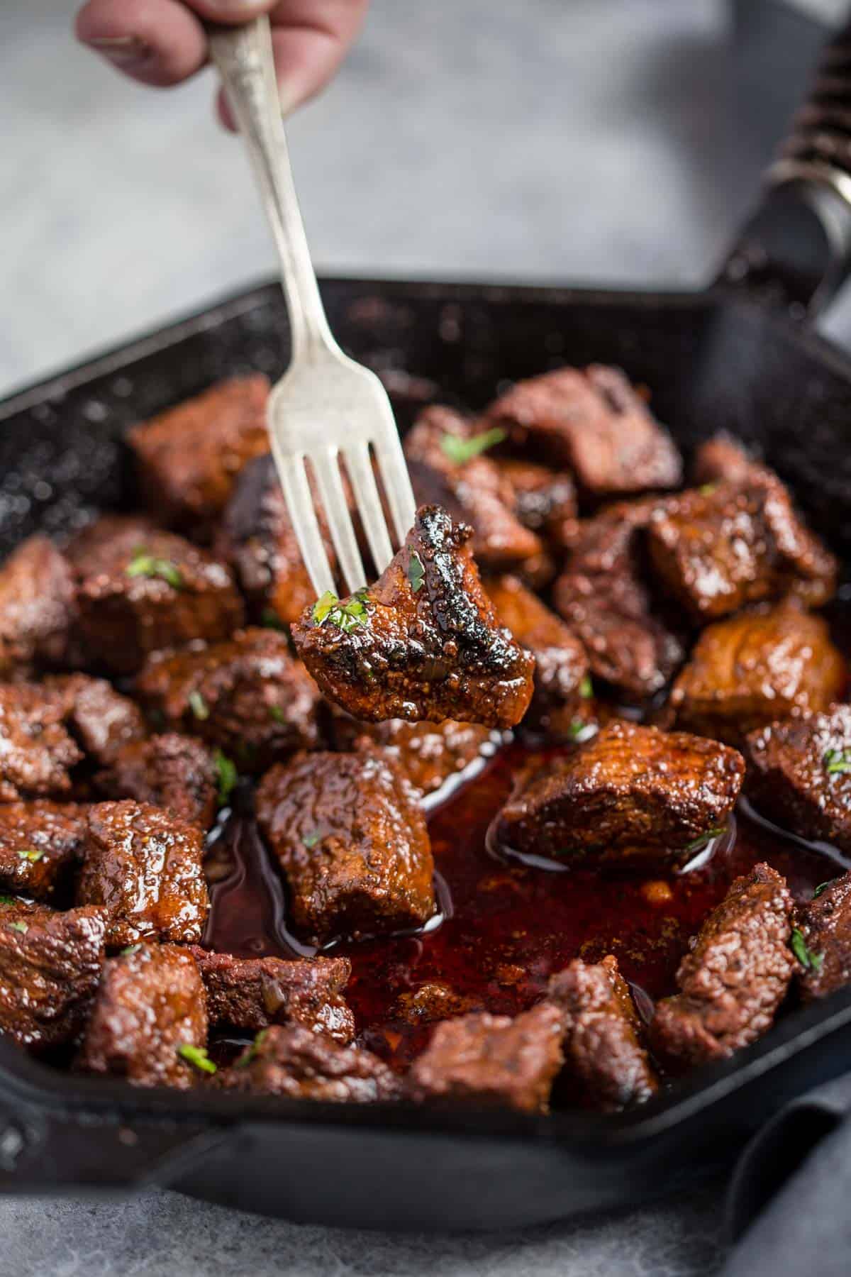 A grilled steak bite on a fork