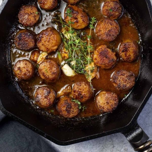 Grilled shrimp in a cast iron pan finished with a butter pan sauce.