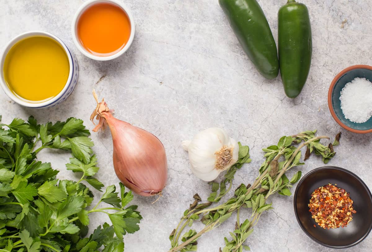 ingredients for jalapeño chimichurri siade on a marble counter