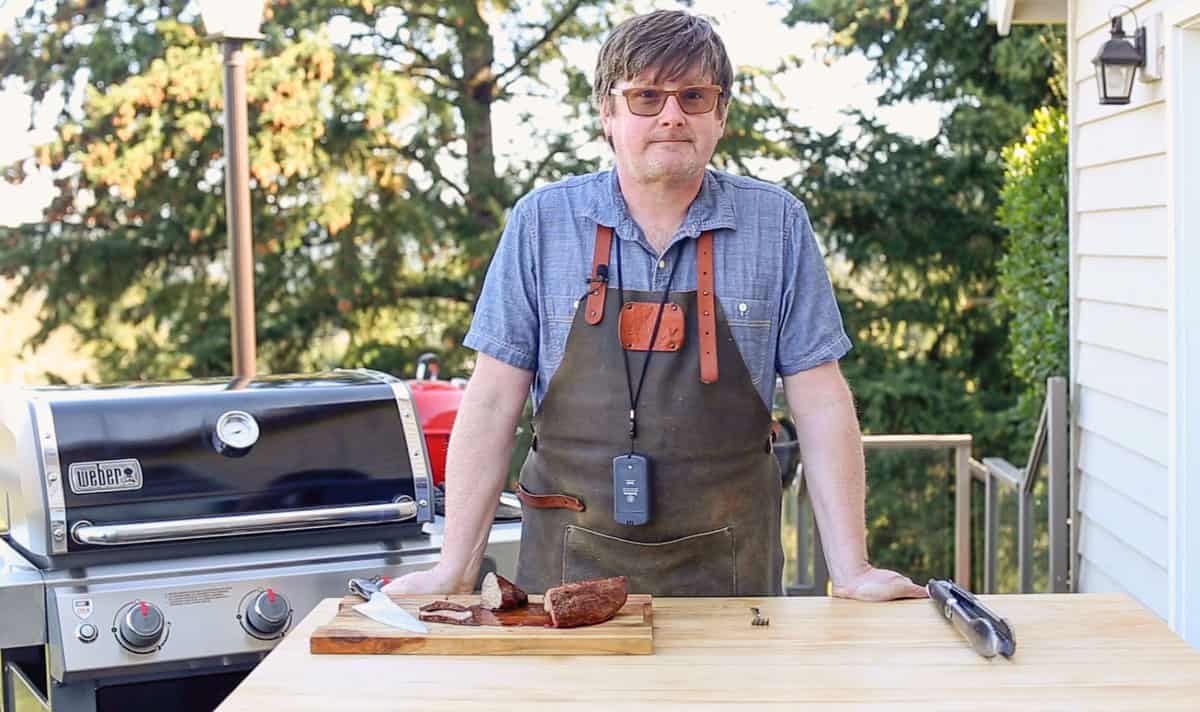 Sean Martin demonstrating how to smoke food in a gas grill
