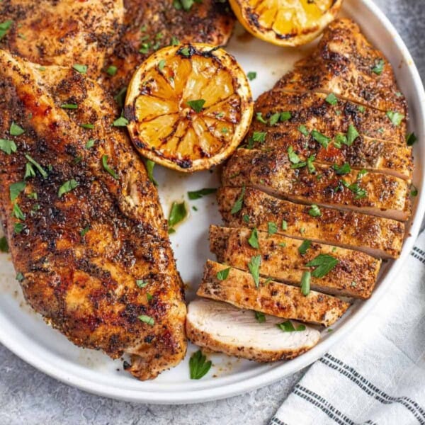 Grilled chicken breast with grilled lemon.