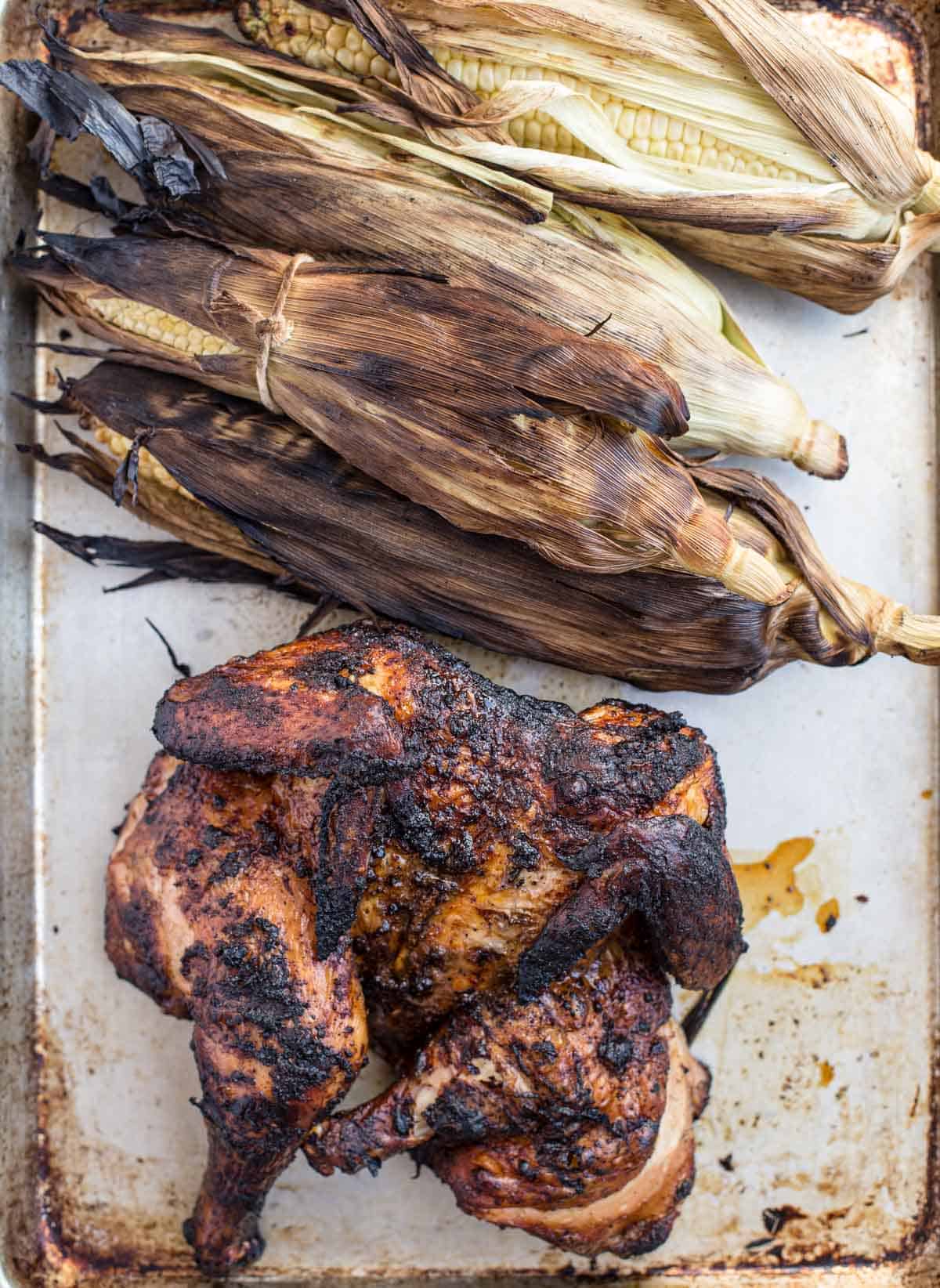 Grilled Corn and a whole Grilled Chicken on a sheet pan