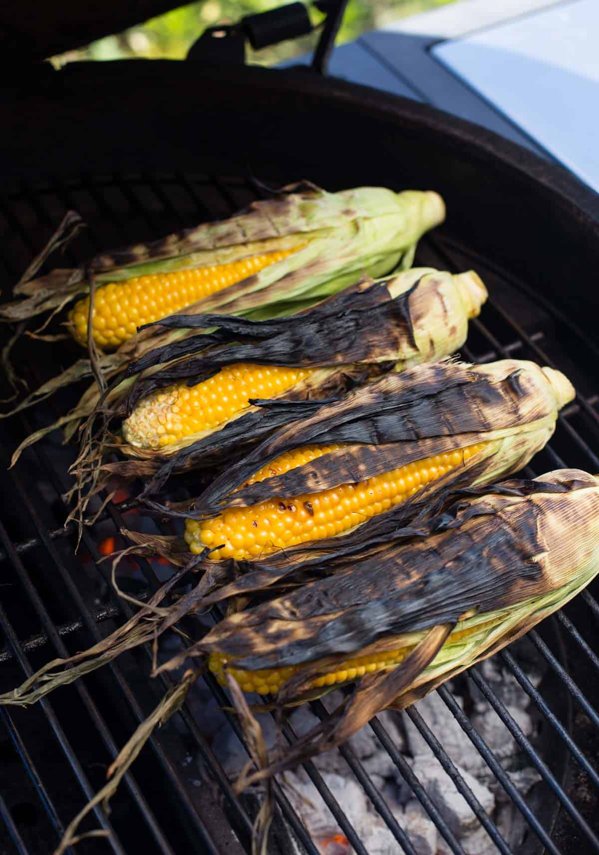 Four ears of corn on a grill