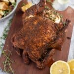 Smoke Roasted Pellet Grill Whole Chicken on a cutting board