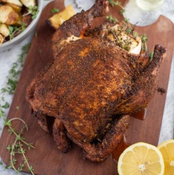 Smoke Roasted Pellet Grill Whole Chicken on a cutting board