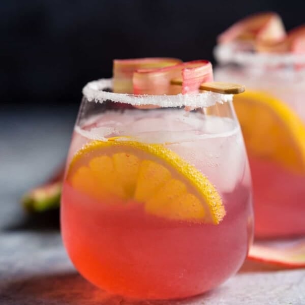 Rhubarb Cocktail in a stemless wine glass with garnish.