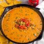 Sausage Queso Bean dip in a cast iron pan