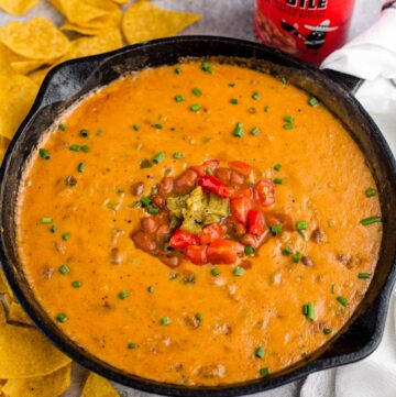 Sausage Queso Bean dip in a cast iron pan