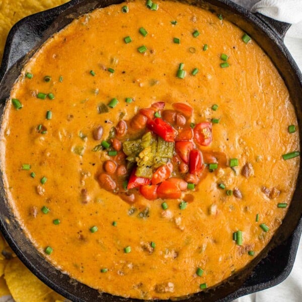 Sausage Queso Bean Dip in a cast iron pan
