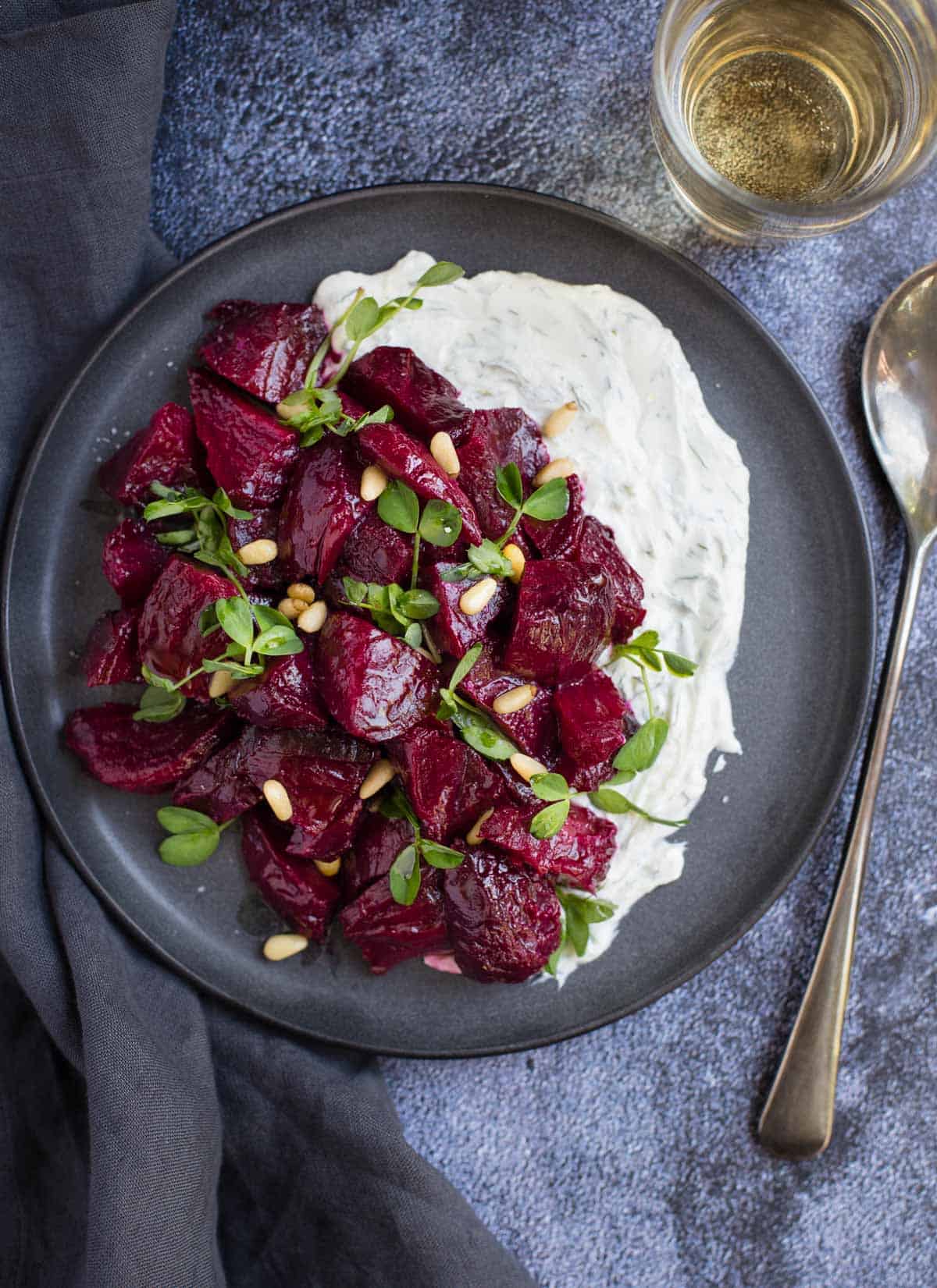 Smoked Beets with Goat Cheese Ranch on a platter with a glass of wine