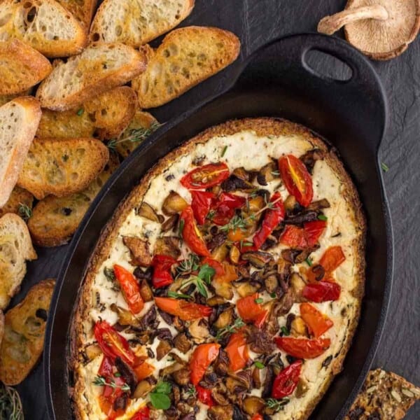 Goat cheese dip with mushrooms in a cast iron pan.