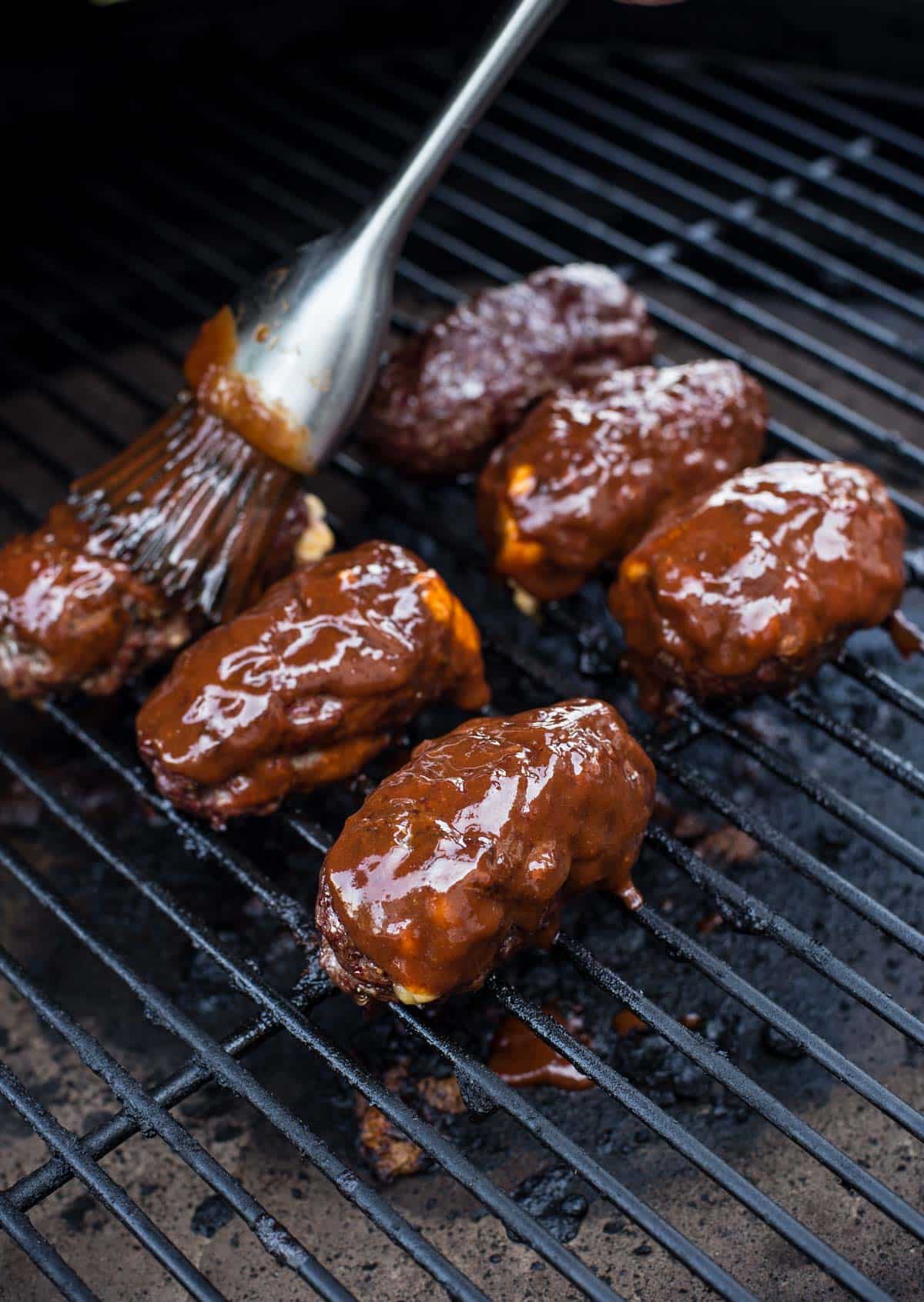 Glazing armadillo eggs with a wine glaze.