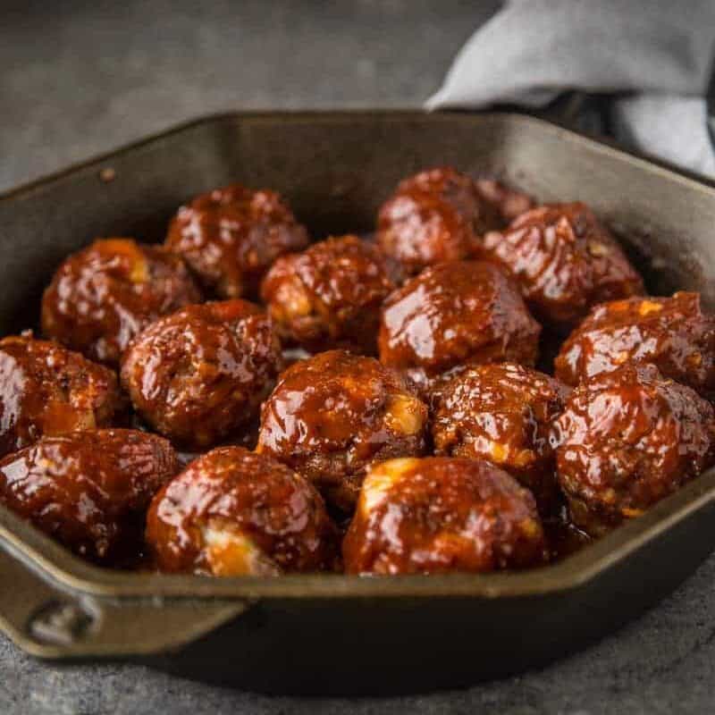 Smoked Stuffed BBQ Meatballs in a cast iron pan