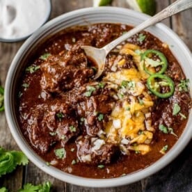 texas chili in a bowl with toppings.