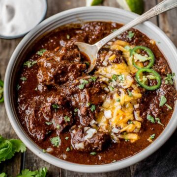 texas chili in a bowl with toppings.
