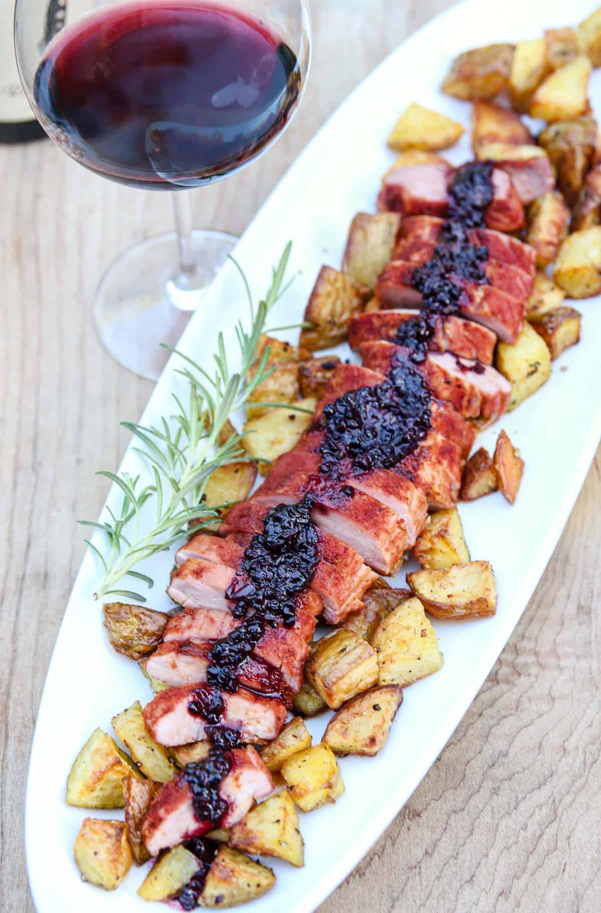 Smoked Pork Tenderloin with Blackberry Bourbon Sauce on a platter