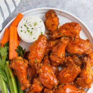 Grilled Buffalo Wings on a plate with ranch.