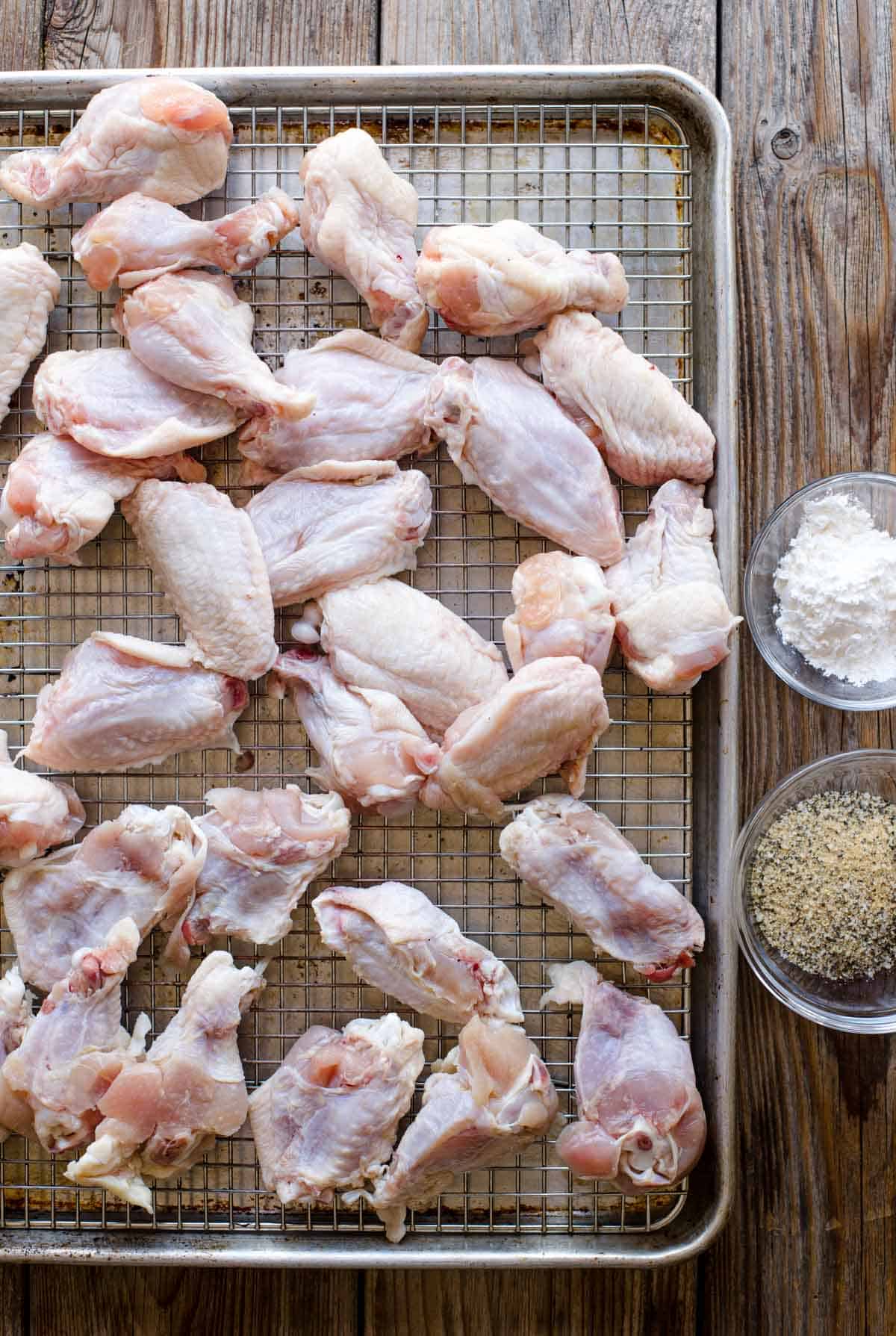 raw chicken wings on a drying rack