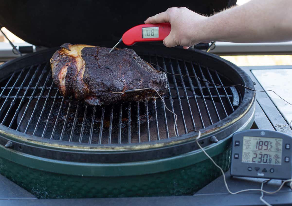 Checking temperature of an easy smoked pork butt using a digital thermometer