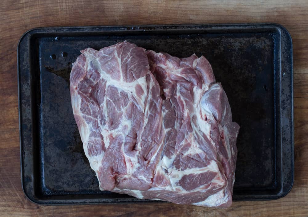 Raw pork butt with marbling on a sheet-an