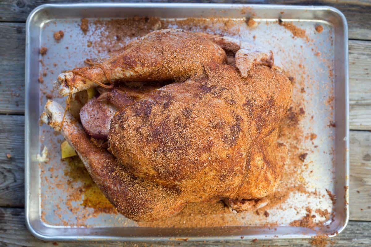 a raw turkey coated with the best turkey seasoning for poultry