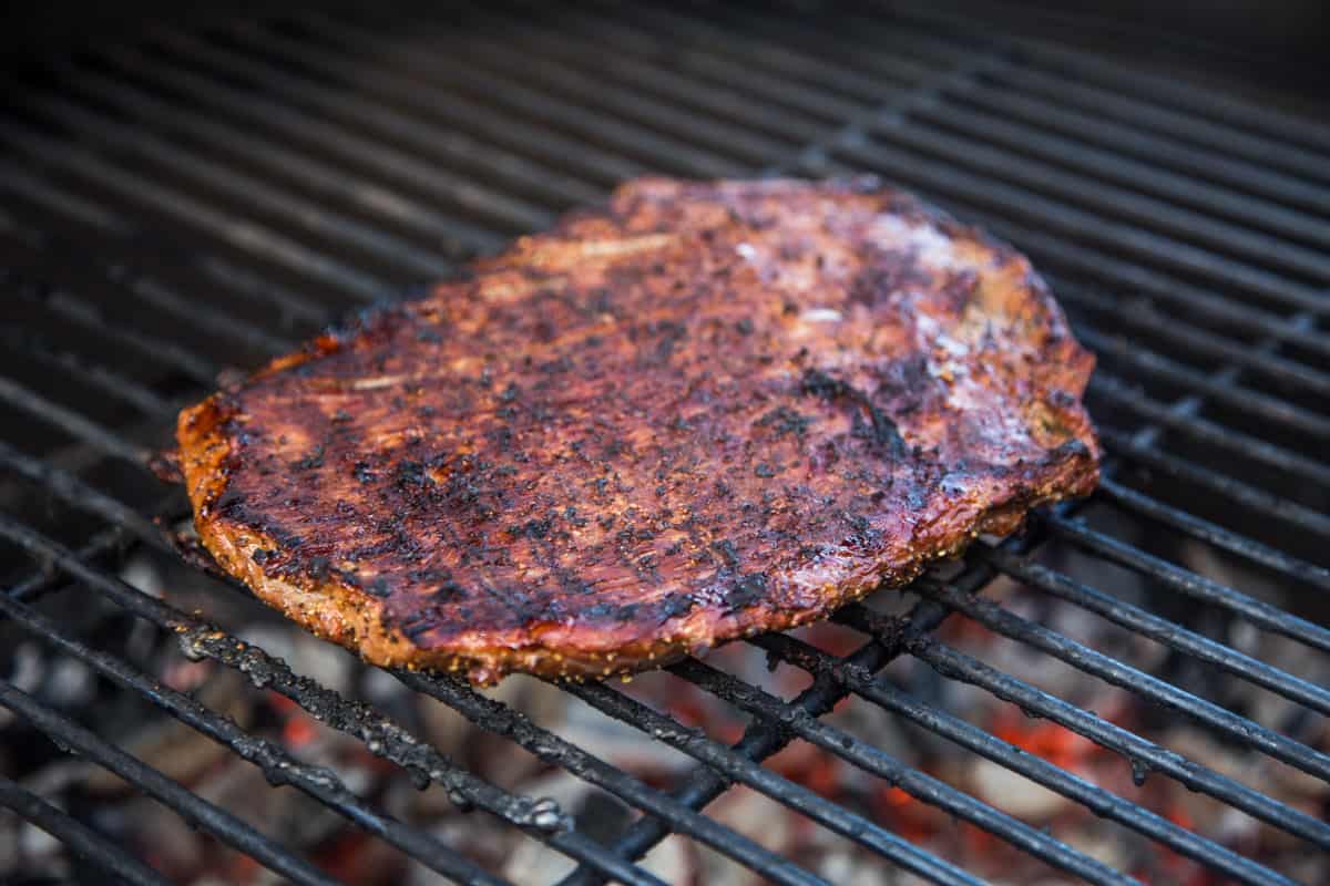 Flank steak cooking on a grill 