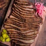 Slices of smoked brisket flat on a cutting board