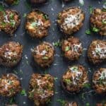 A serving platter of smoked and stuffed sausage mushrooms.