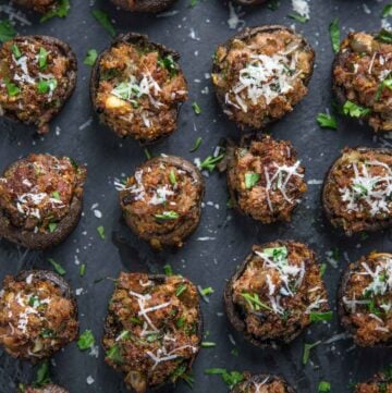 A serving platter of smoked and stuffed sausage mushrooms.