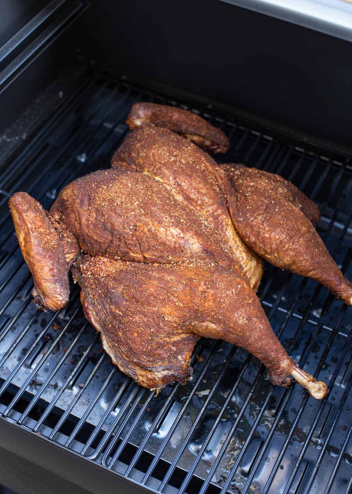 A spatchcocked turkey on the smoker