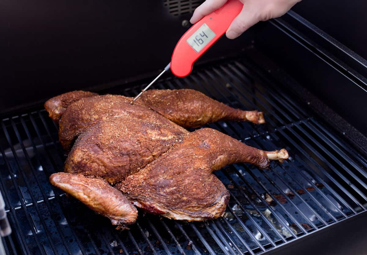 taking the temperature of a spatchcocked turkey with a Thermoworks Thermapen One digital thermometer