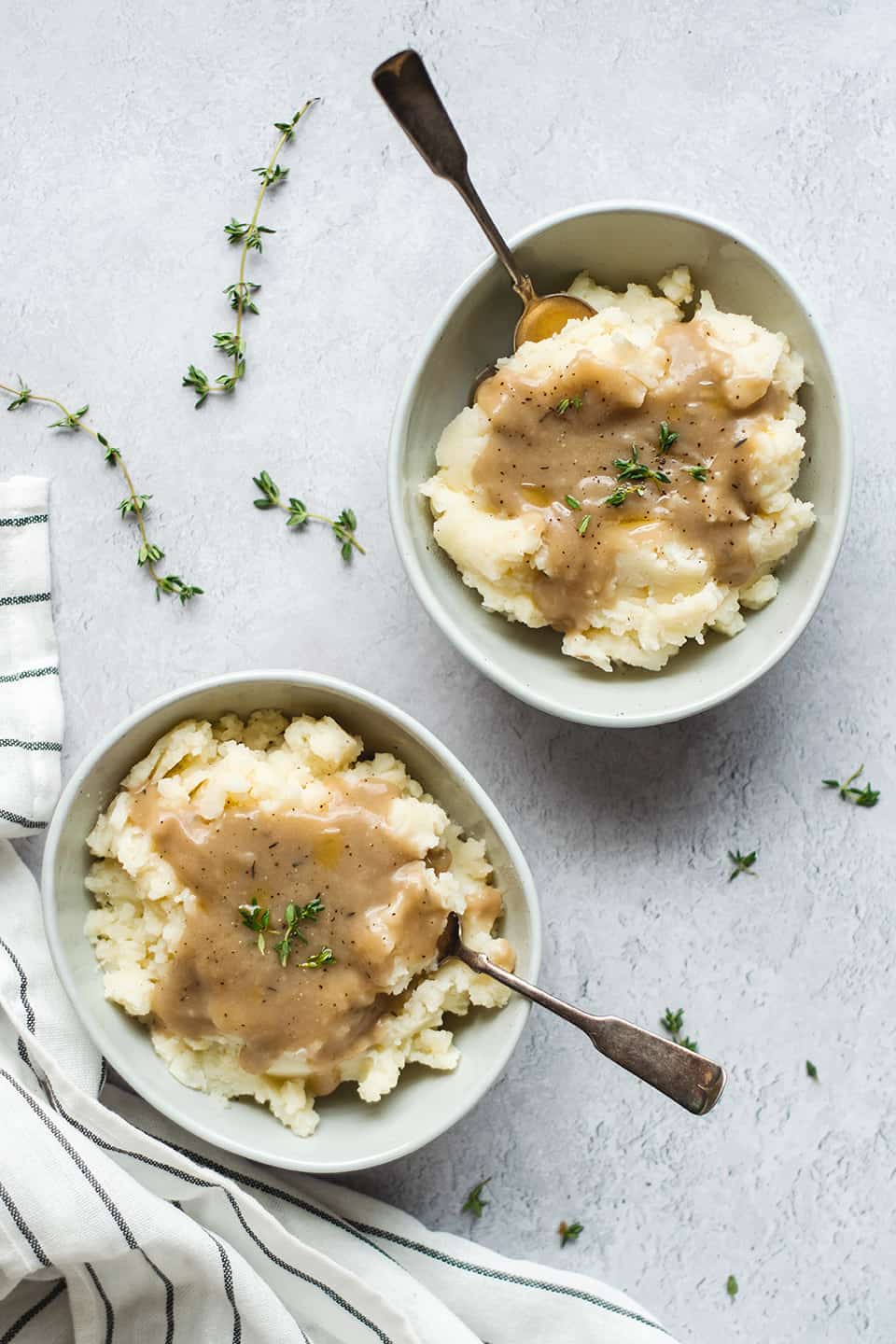 Smoked turkey gravy over mashed potatoes in a bowl.