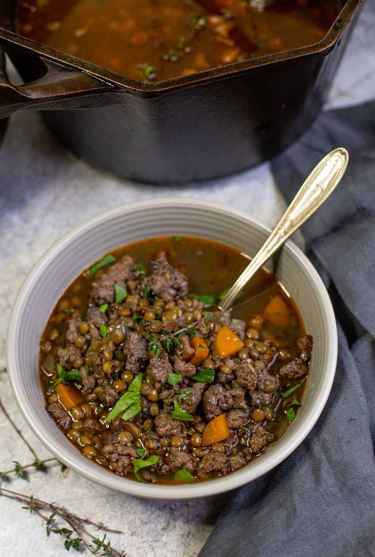 A bowl of smoked sausage and lentil soup