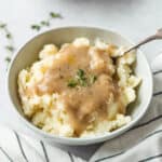 Smoked turkey gravy in a platter with a serving spoon