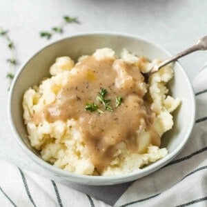 Smoked turkey gravy in a platter with a serving spoon