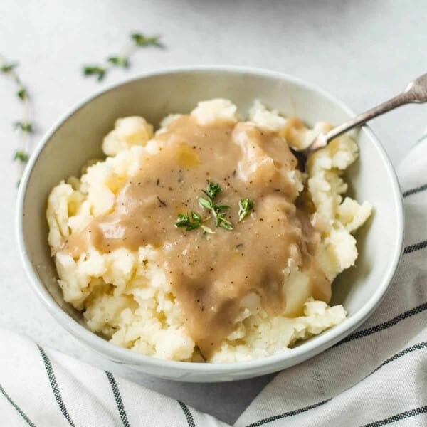 Smoked turkey gravy in a platter with a serving spoon