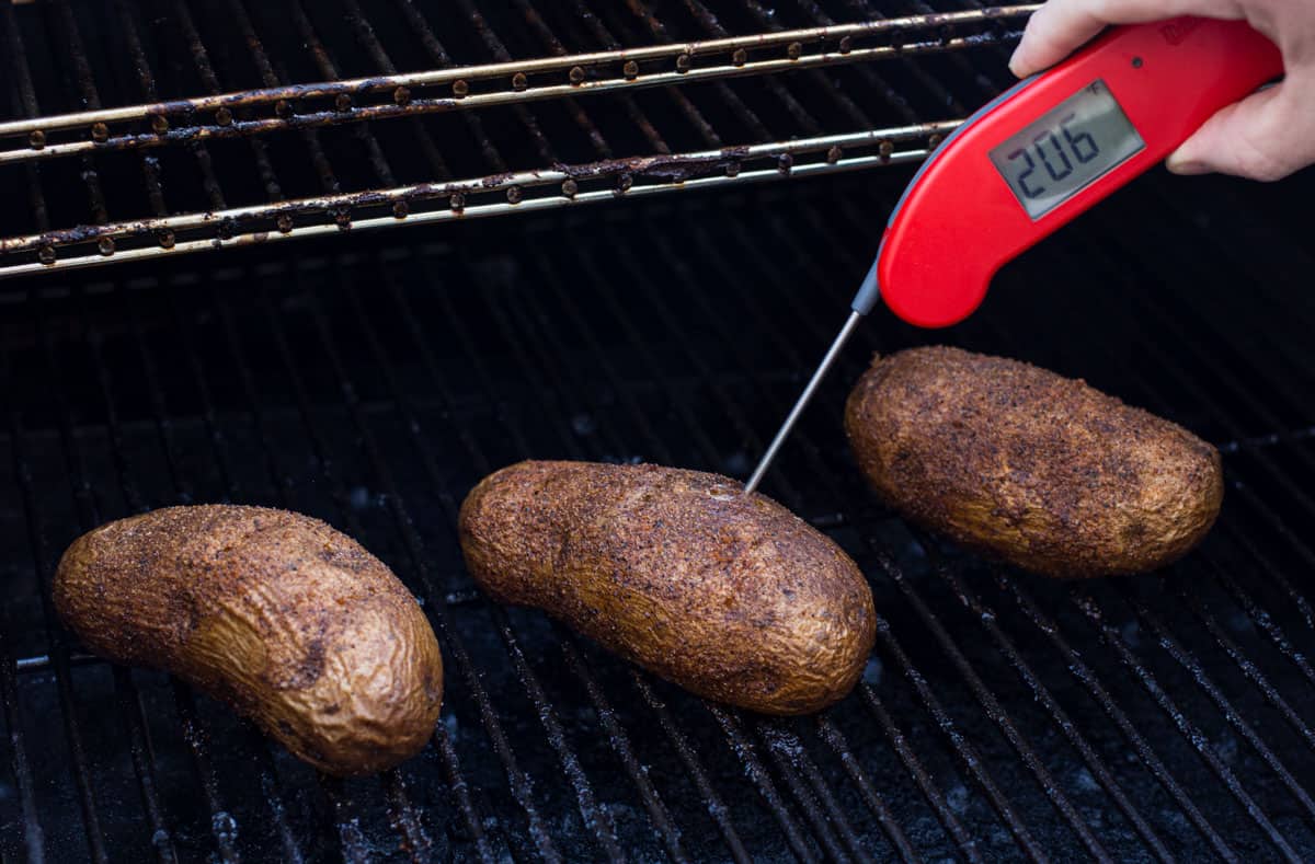 Smoked Baked Potatoes with a thermometer reading 206 degrees