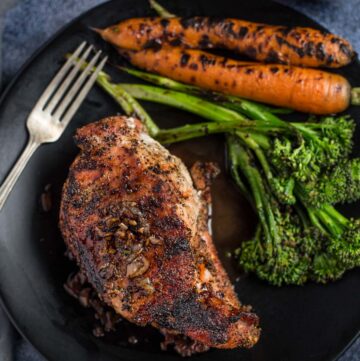 Bone in Grilled Pork Chops with a side of carrots and broccolini.