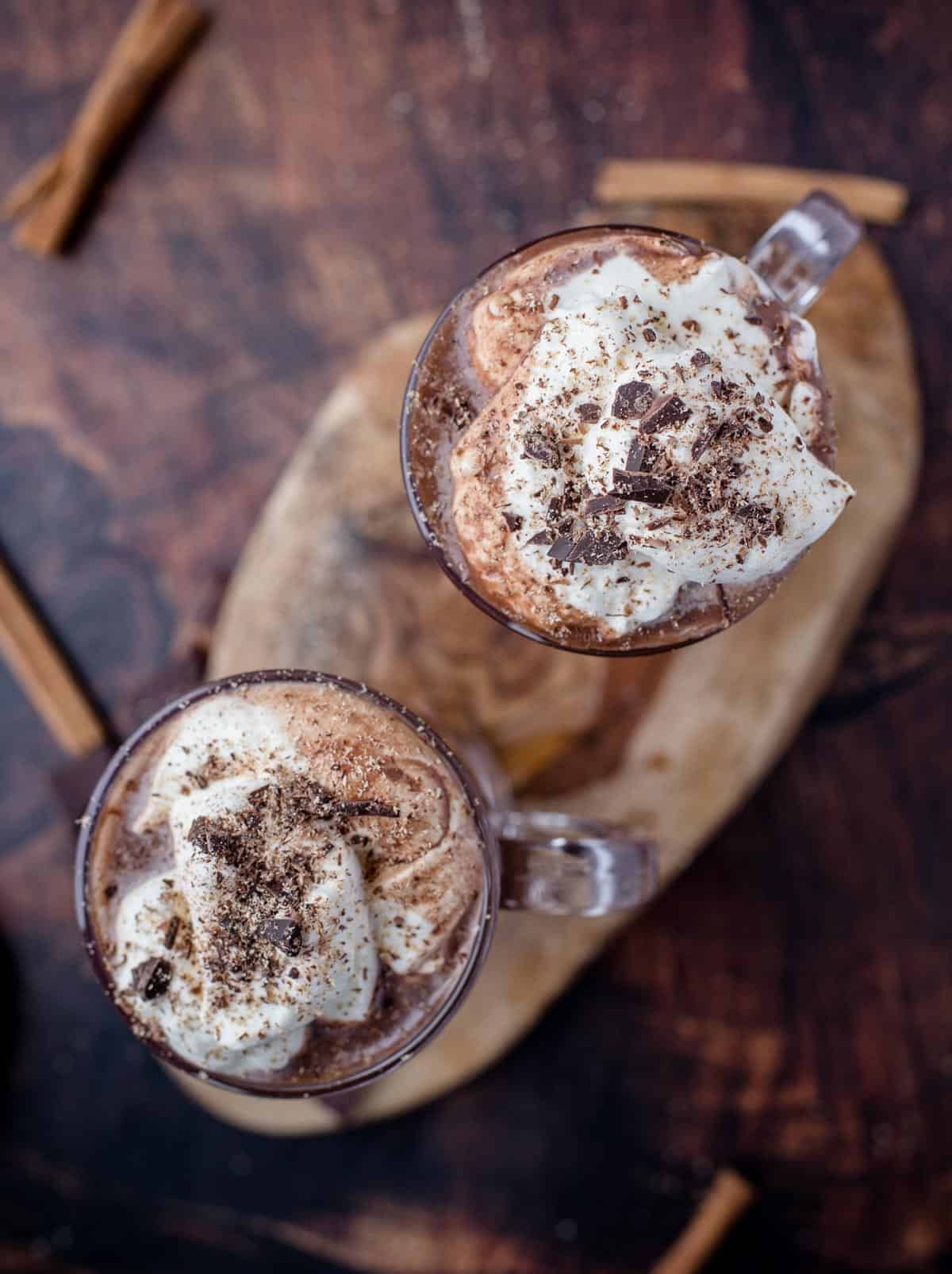 A top down view of two glasses of smoked hot chocolate