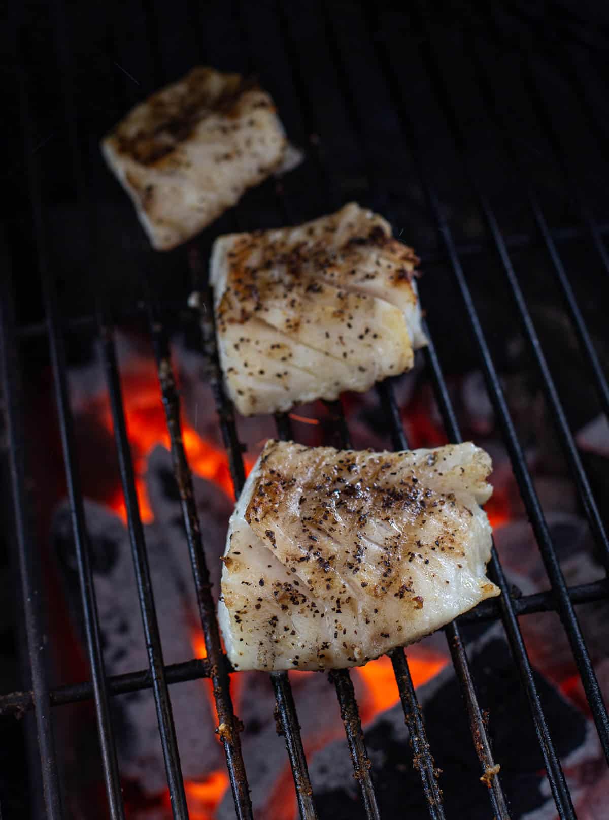 Three Cod Filets cooking on the grill
