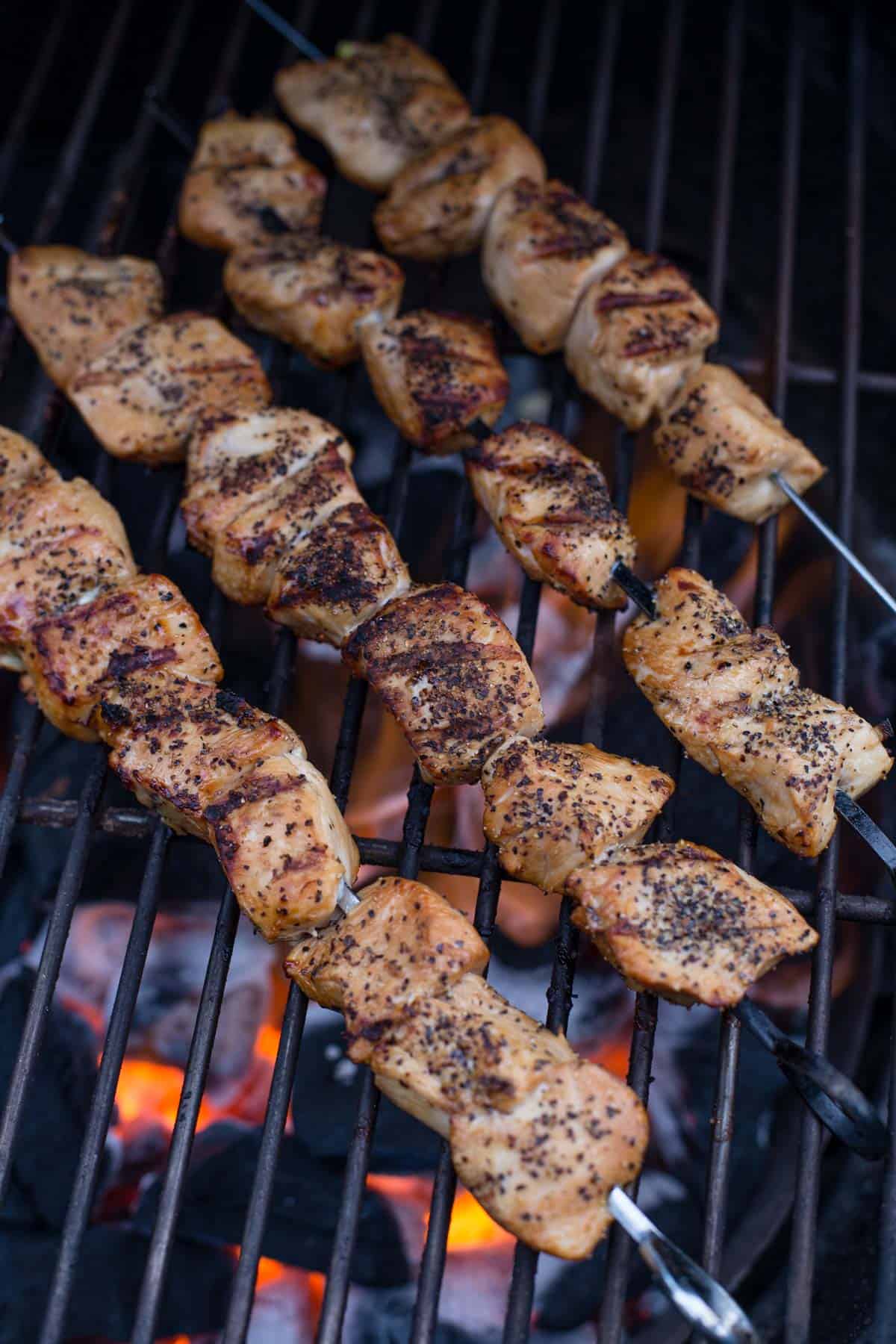 marinated chicken skewers on the grill