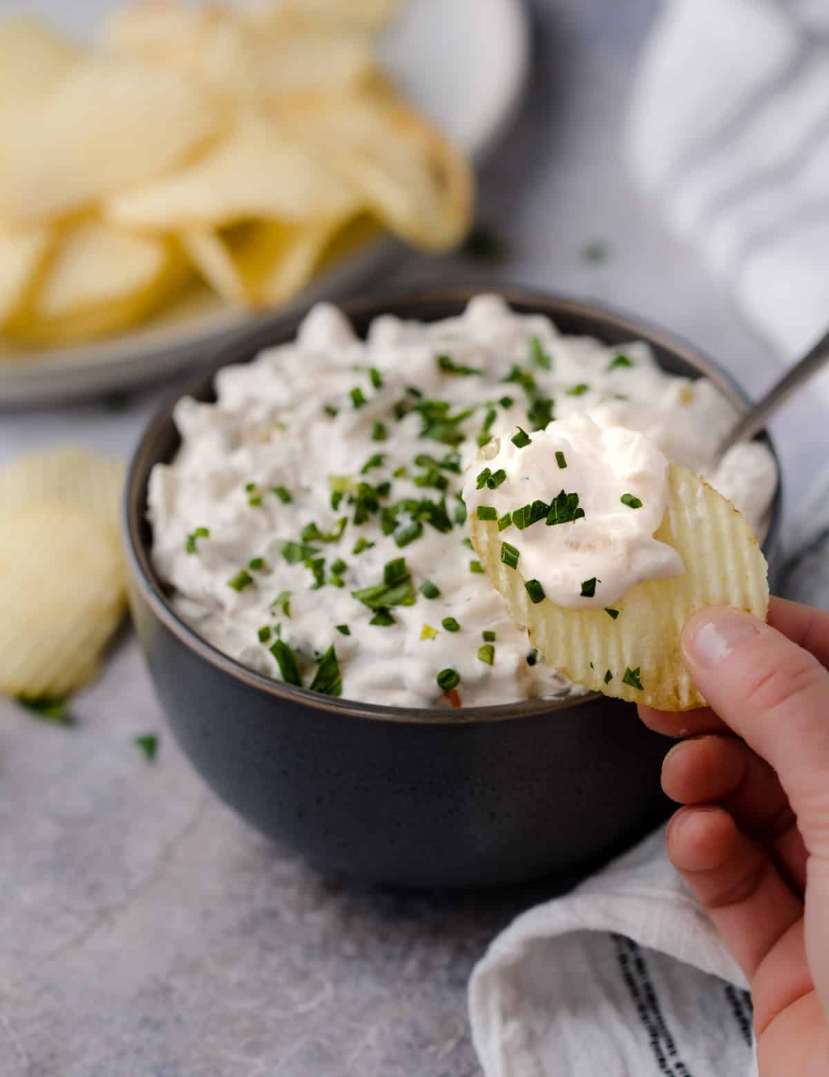 Dipping a chip into smoked French onion dip.