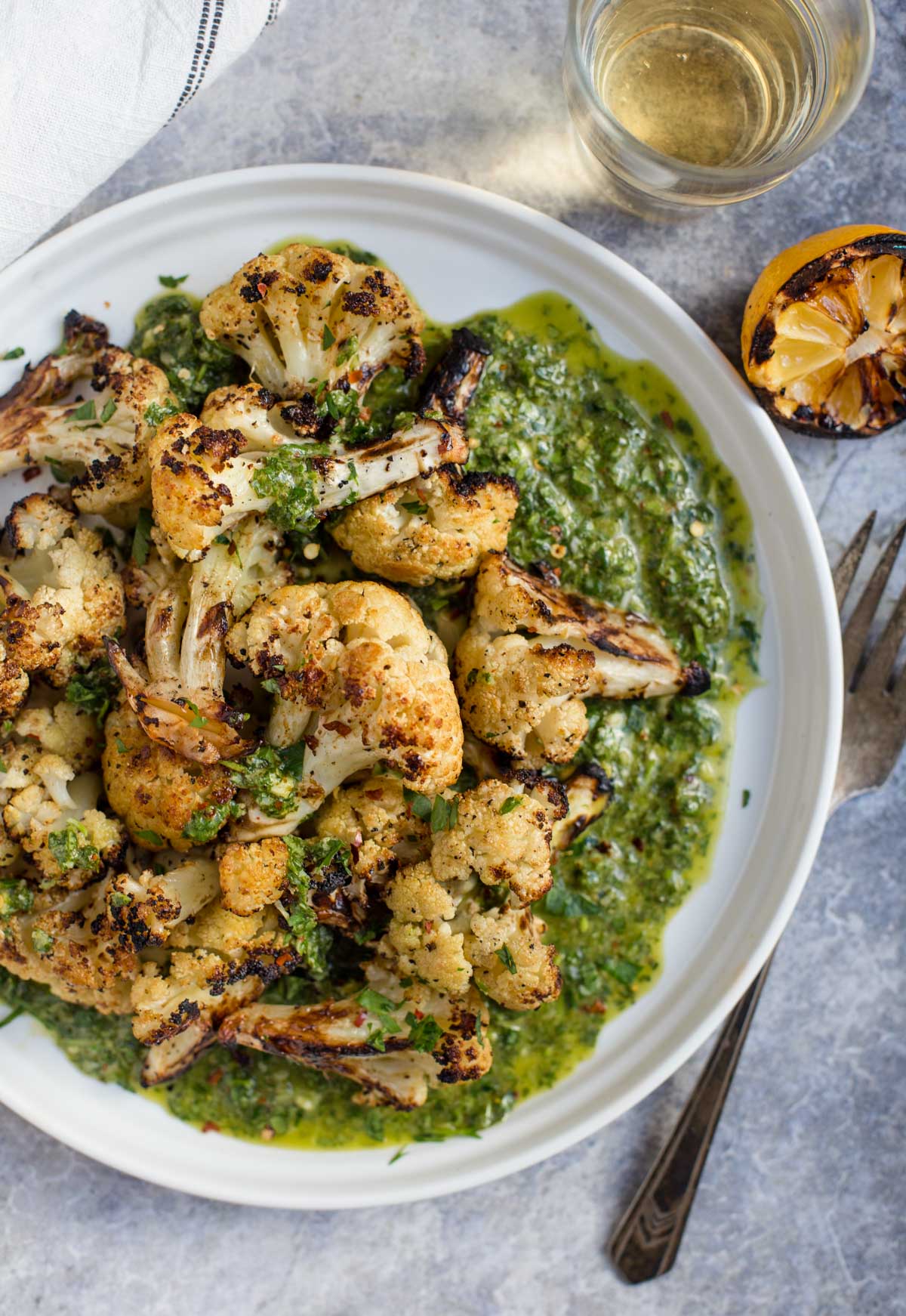 Grilled Cauliflower with a cilantro Pistou on a white platter