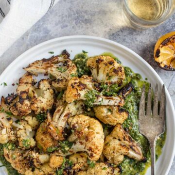 Grilled Cauliflower florets on plate with Pistou sauce.