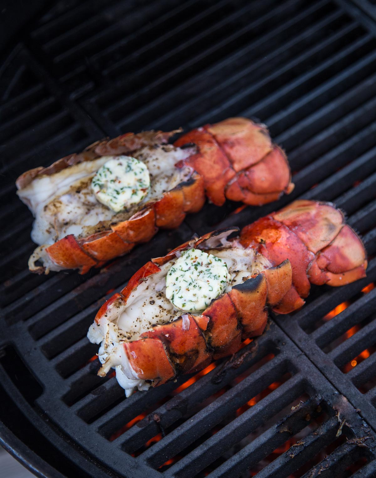 Two Lobster tails grilling on the grill