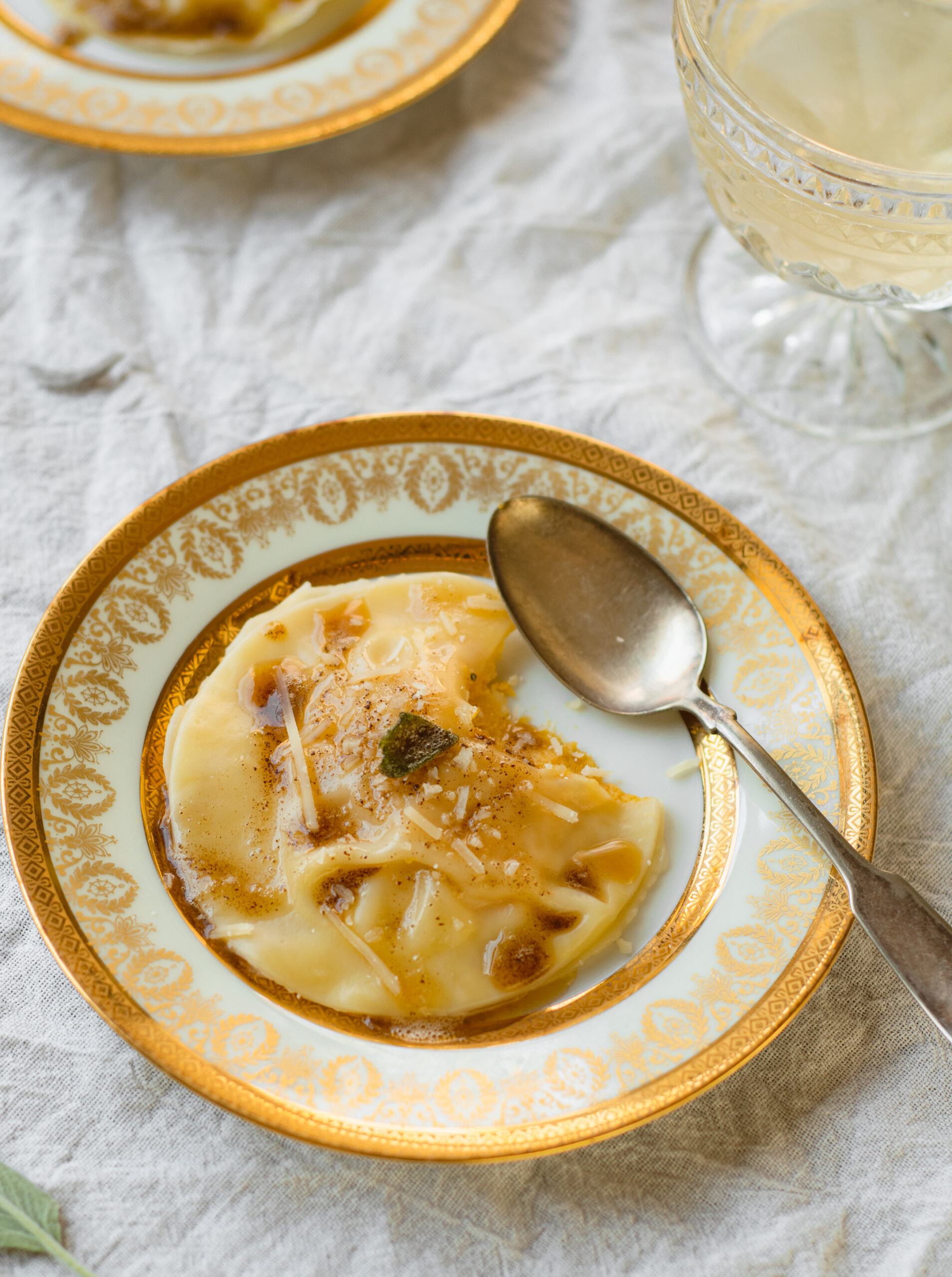 pumpkin ravioli on a plate with a spoon