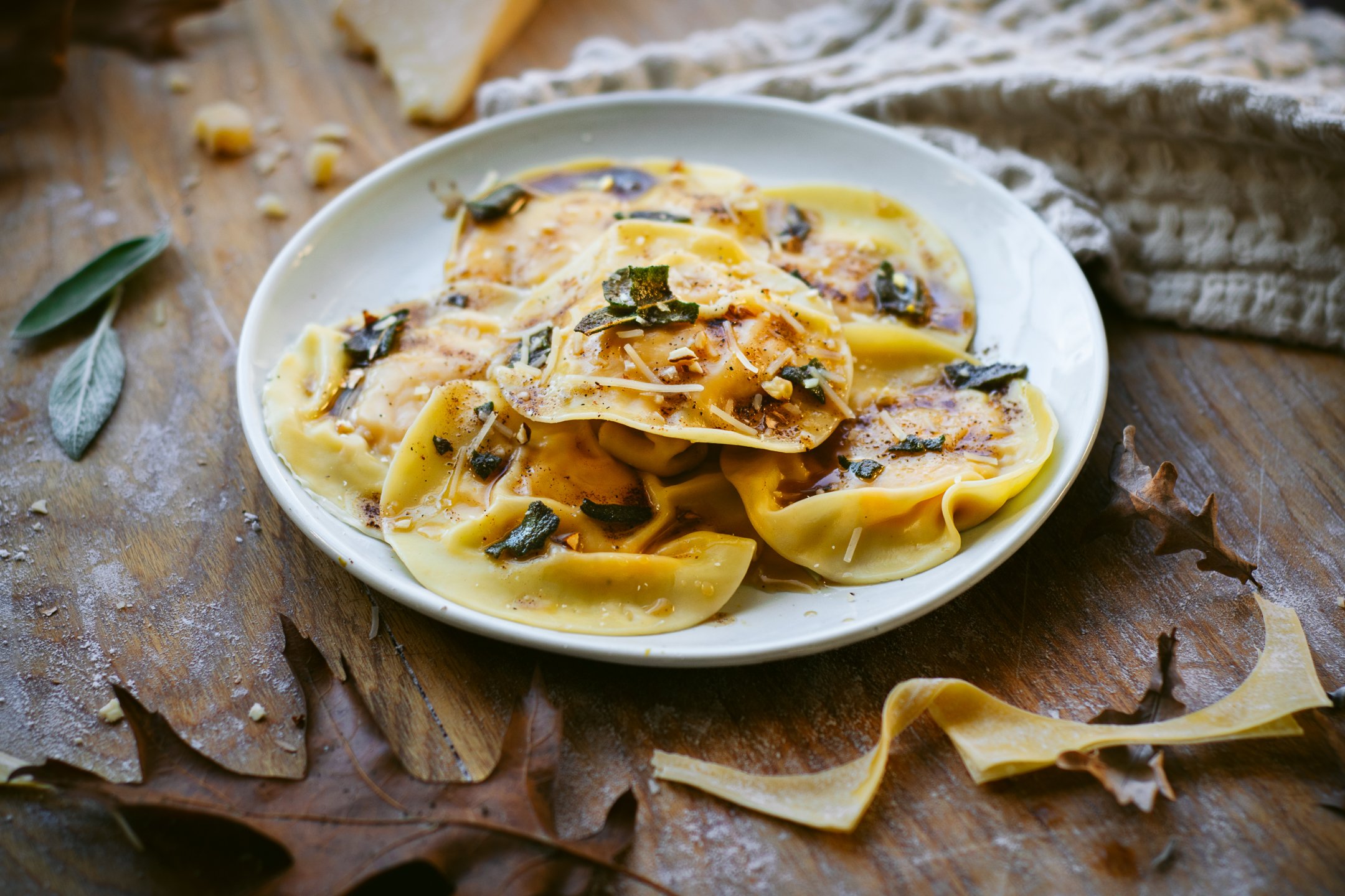 A plate of pumpkin ravioli on a wooden background
